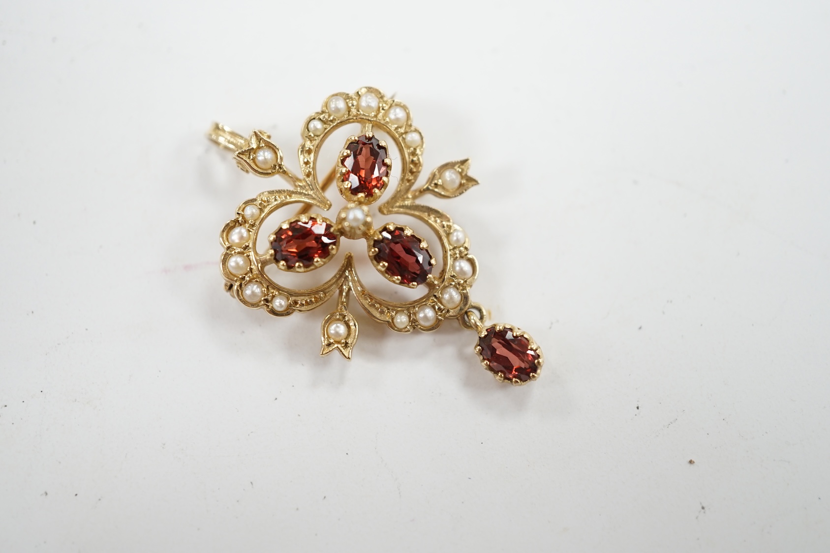 A Victorian style 9ct gold, garnet and seed pearl set drop pendant brooch, overall 39mm, gross weight 5.7 grams. Condition - fair to good